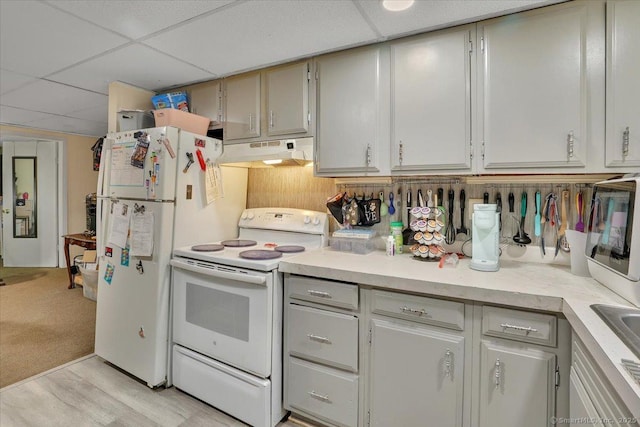 124 Main St, Sprague, CT 06330 - kitchen featuring white appliances, under cabinet range hood, light countertops, a drop ceiling, and light wood-style floors