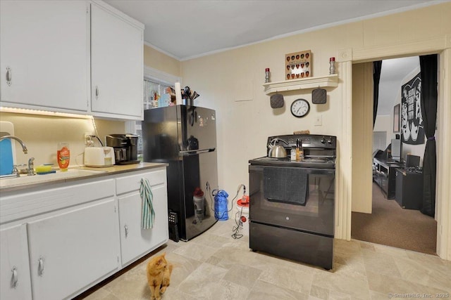 124 Main St, Sprague, CT 06330 - kitchen with black appliances, light countertops, white cabinets, and ornamental molding
