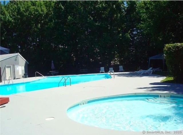 80 County St Apt 7K, Norwalk, CT 06851 - community pool featuring a patio area and an outbuilding
