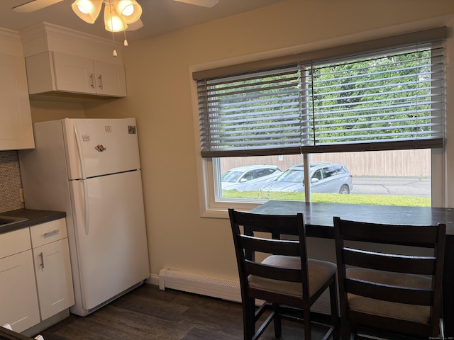 80 County St Apt 7K, Norwalk, CT 06851 - dining room featuring ceiling fan, dark wood finished floors, a baseboard radiator, and baseboards