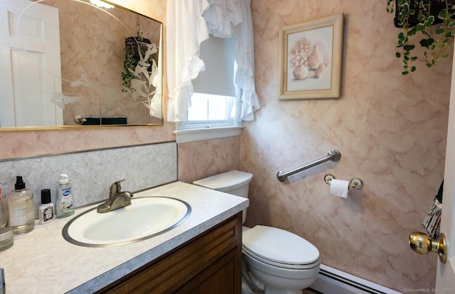 30 Dwight Rd, Middlefield, CT 06455 - bathroom with a baseboard radiator, toilet, vanity, and backsplash