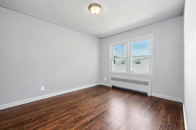 103 Anthony St, New Haven, CT 06515 - unfurnished room featuring radiator heating unit, dark wood-style floors, and a textured ceiling