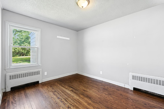 103 Anthony St, New Haven, CT 06515 - unfurnished room with radiator heating unit, dark wood finished floors, and a textured ceiling