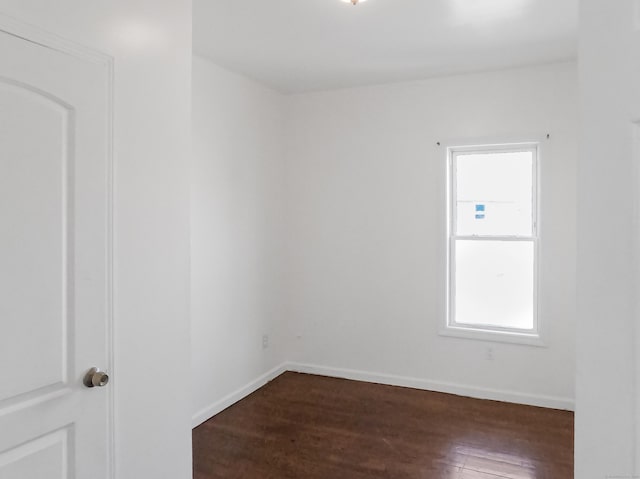 1169 Iranistan Ave, Bridgeport, CT 06605 - spare room with healthy amount of natural light, dark wood-type flooring, and baseboards
