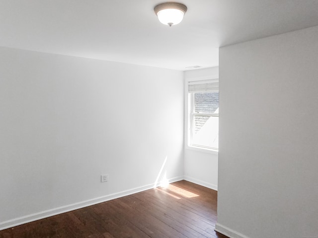 1169 Iranistan Ave, Bridgeport, CT 06605 - empty room featuring dark wood-style flooring and baseboards