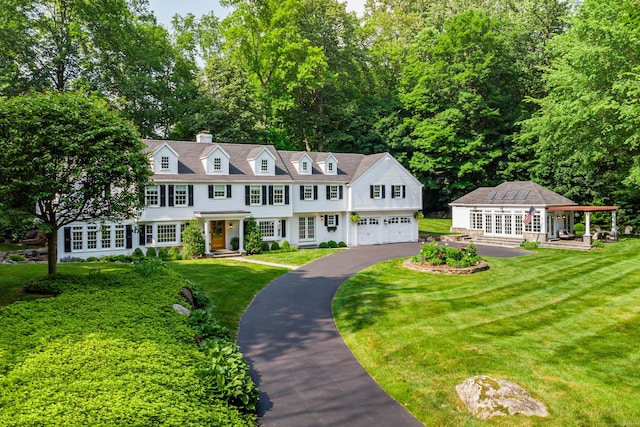 20 Copper Beech Ln, Ridgefield, CT 06877 - shingle-style home with driveway, a front lawn, an attached garage, and a chimney