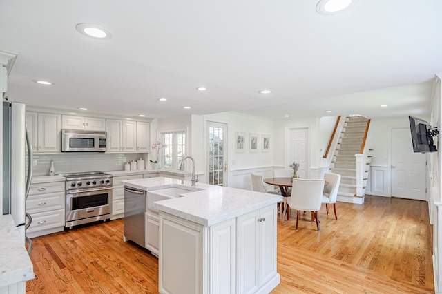 20 Copper Beech Ln, Ridgefield, CT 06877 - kitchen featuring appliances with stainless steel finishes, light wood finished floors, white cabinets, backsplash, and recessed lighting