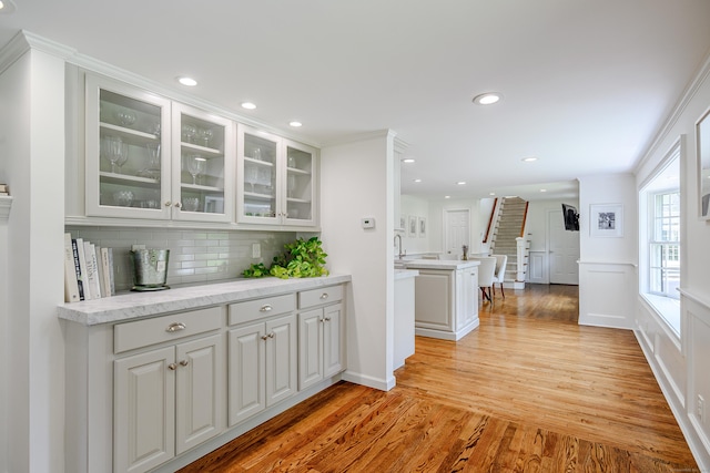 20 Copper Beech Ln, Ridgefield, CT 06877 - kitchen featuring tasteful backsplash, light wood finished floors, white cabinetry, glass insert cabinets, and recessed lighting
