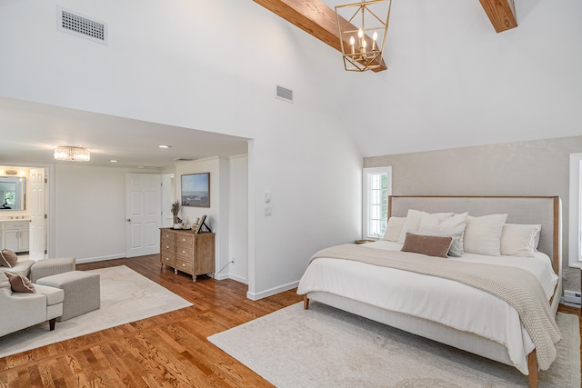 20 Copper Beech Ln, Ridgefield, CT 06877 - bedroom featuring a chandelier, wood finished floors, high vaulted ceiling, baseboards, and ensuite bath