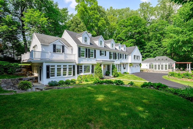 20 Copper Beech Ln, Ridgefield, CT 06877 - shingle-style home with driveway, a balcony, a front yard, french doors, and a shingled roof