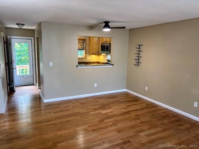41 High St Apt 2, East Haven, CT 06512 - empty room featuring a ceiling fan, wood finished floors, and baseboards