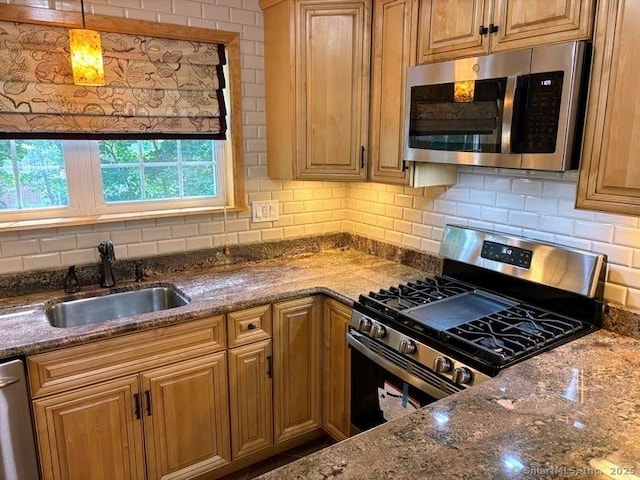 41 High St Apt 2, East Haven, CT 06512 - kitchen featuring stainless steel appliances, a sink, backsplash, and dark stone countertops