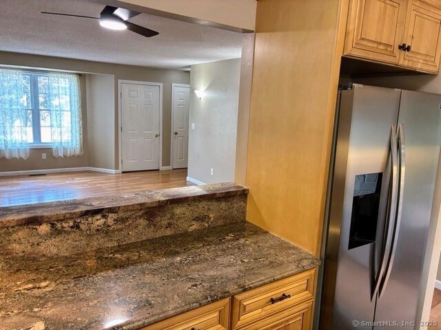 41 High St Apt 2, East Haven, CT 06512 - kitchen featuring stainless steel fridge, wood finished floors, ceiling fan, dark stone countertops, and baseboards