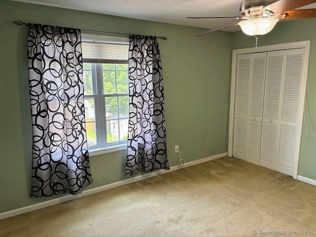 41 High St Apt 2, East Haven, CT 06512 - unfurnished bedroom with carpet floors, baseboards, a closet, and ceiling fan
