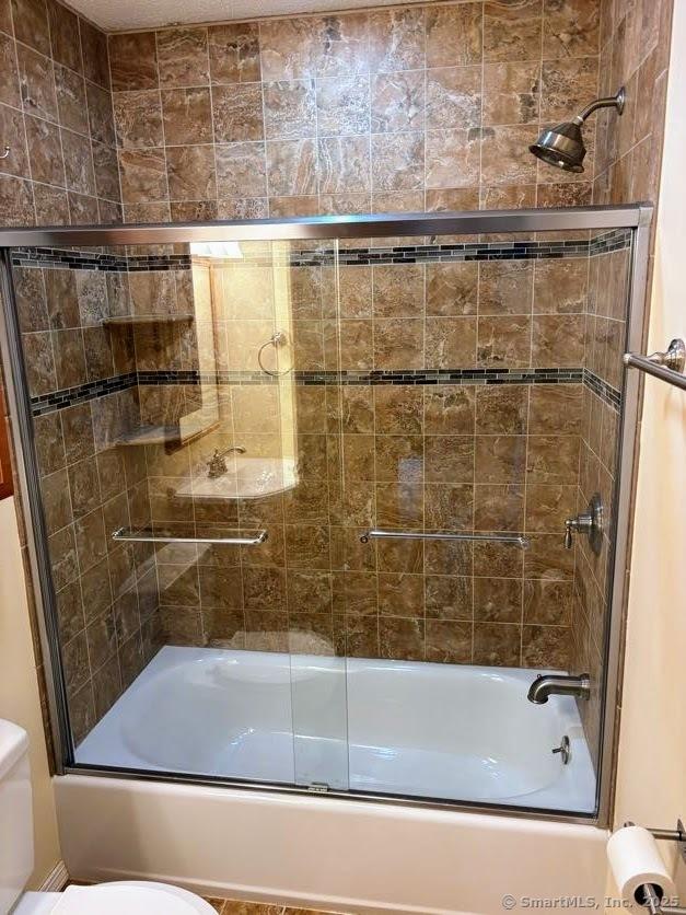 41 High St Apt 2, East Haven, CT 06512 - bathroom featuring toilet and shower / bath combination with glass door