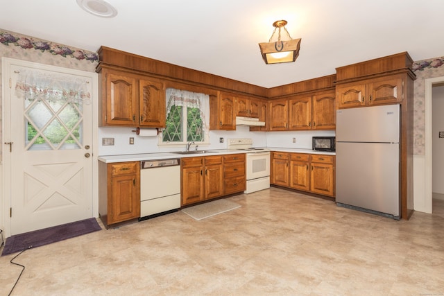 190 Allerton Farms Rd, Middlebury, CT 06762 - kitchen with white appliances, under cabinet range hood, brown cabinets, and light countertops