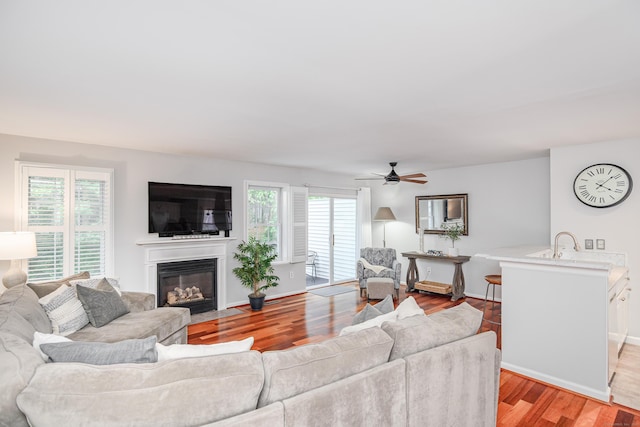 2006 Hancock Dr Unit 2006, Danbury, CT 06811 - living room featuring plenty of natural light, a fireplace with flush hearth, light wood-type flooring, and ceiling fan