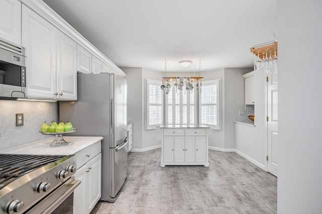 2006 Hancock Dr Unit 2006, Danbury, CT 06811 - kitchen featuring stainless steel appliances, decorative backsplash, white cabinetry, and light countertops