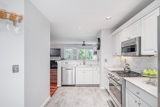 2006 Hancock Dr Unit 2006, Danbury, CT 06811 - kitchen featuring appliances with stainless steel finishes, ceiling fan, light wood-type flooring, tasteful backsplash, and recessed lighting