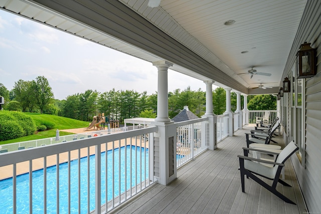 2006 Hancock Dr Unit 2006, Danbury, CT 06811 - wooden deck featuring a ceiling fan, a playground, and view of wooded area