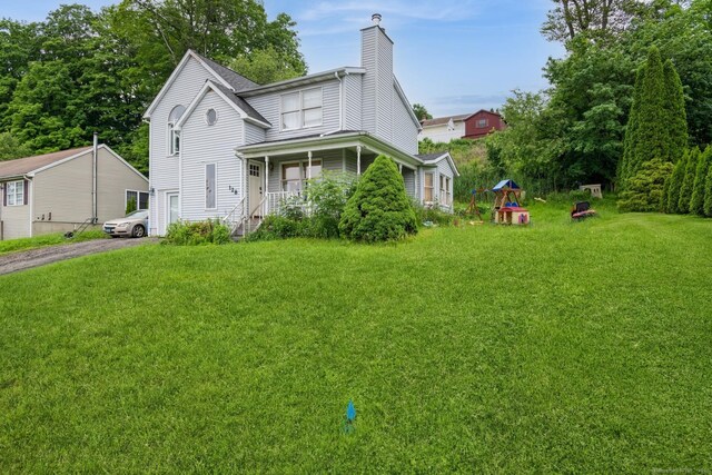 128 Santa Maria Dr, Torrington, CT 06790 - view of front of property featuring a chimney, a front lawn, and driveway