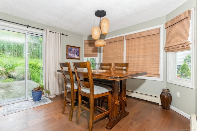 128 Santa Maria Dr, Torrington, CT 06790 - dining room with a baseboard heating unit, wood finished floors, and a textured ceiling