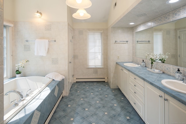 75 Bald Hill Rd, Wilton, CT 06897 - full bathroom featuring a baseboard radiator, tile walls, a bath, double vanity, and tile patterned flooring