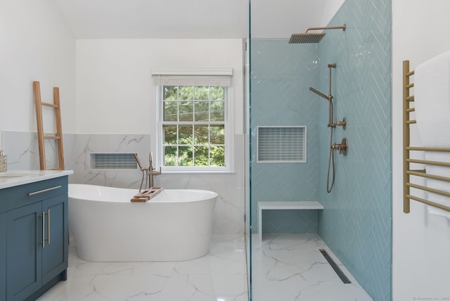 75 Bald Hill Rd, Wilton, CT 06897 - bathroom featuring a towel warming rack, marble tiled floors, a soaking tub, vanity, and a tile shower