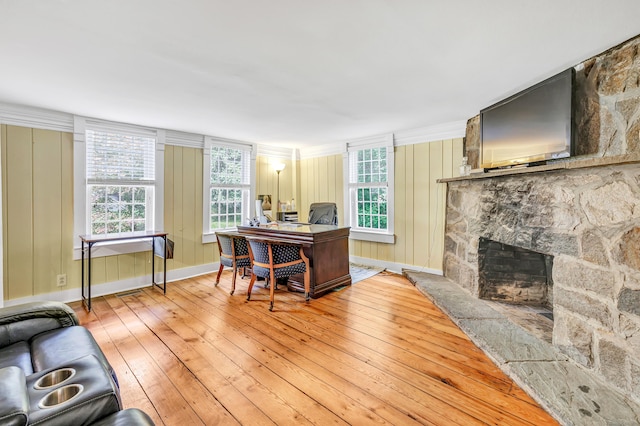 120 Huntington St, Shelton, CT 06484 - home office with light wood-style flooring, a stone fireplace, and baseboards