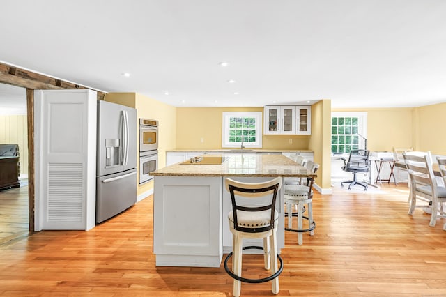 120 Huntington St, Shelton, CT 06484 - kitchen with appliances with stainless steel finishes, a kitchen island, healthy amount of natural light, light wood finished floors, and recessed lighting
