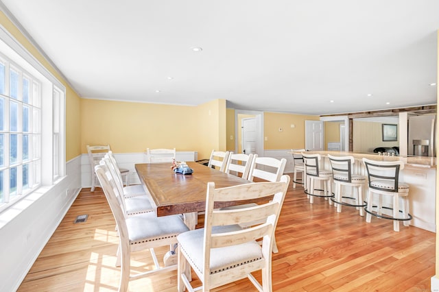 120 Huntington St, Shelton, CT 06484 - dining room featuring light wood-style flooring, a wainscoted wall, ornamental molding, and recessed lighting