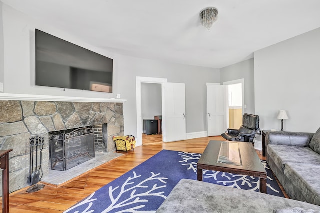 120 Huntington St, Shelton, CT 06484 - living area featuring wood finished floors, a stone fireplace, and baseboards
