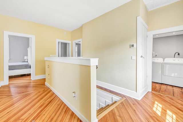 120 Huntington St, Shelton, CT 06484 - corridor with washer and clothes dryer, light wood finished floors, baseboards, and an upstairs landing
