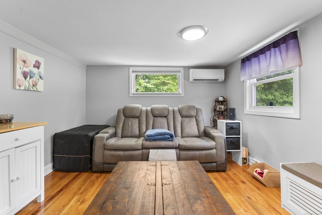 188 W Main St, East Lyme, CT 06357 - living room with a wall unit AC, light wood-style flooring, and healthy amount of natural light