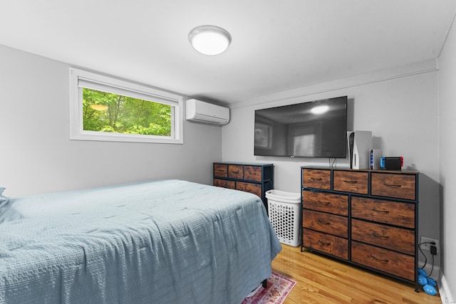 188 W Main St, East Lyme, CT 06357 - bedroom with an AC wall unit and light wood-type flooring