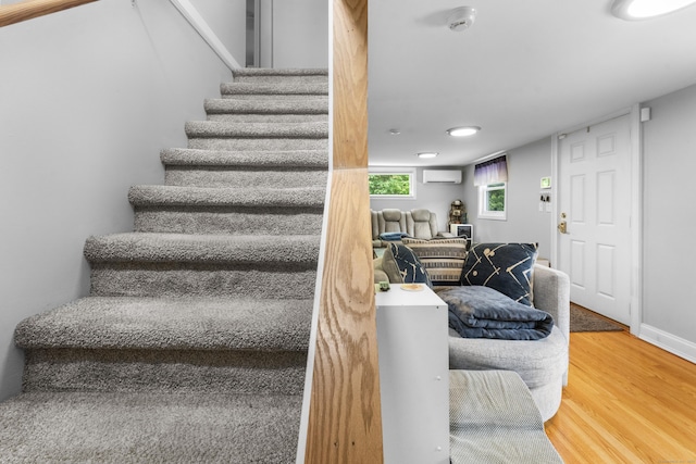 188 W Main St, East Lyme, CT 06357 - stairs featuring a wall unit AC, wood finished floors, and recessed lighting