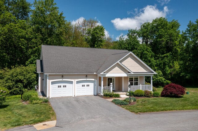 9 Benjamin Ln Unit 9, Tolland, CT 06084 - view of front of house featuring a porch, a garage, driveway, and a front lawn
