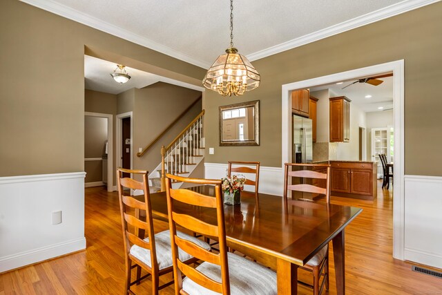 9 Benjamin Ln Unit 9, Tolland, CT 06084 - dining room featuring light wood-type flooring, a chandelier, ornamental molding, ceiling fan, and stairway