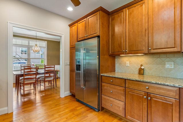 9 Benjamin Ln Unit 9, Tolland, CT 06084 - kitchen featuring stainless steel refrigerator with ice dispenser, brown cabinetry, light wood finished floors, decorative backsplash, and recessed lighting
