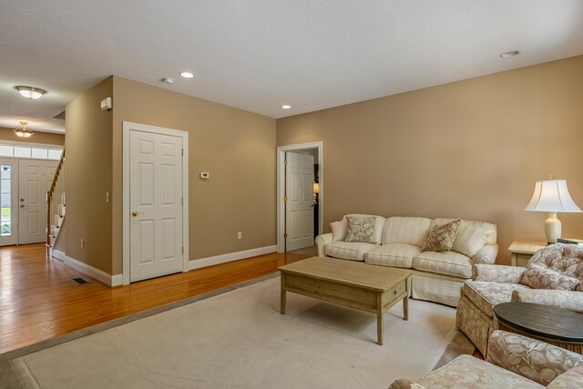 9 Benjamin Ln Unit 9, Tolland, CT 06084 - living area featuring light wood finished floors, baseboards, recessed lighting, and stairway