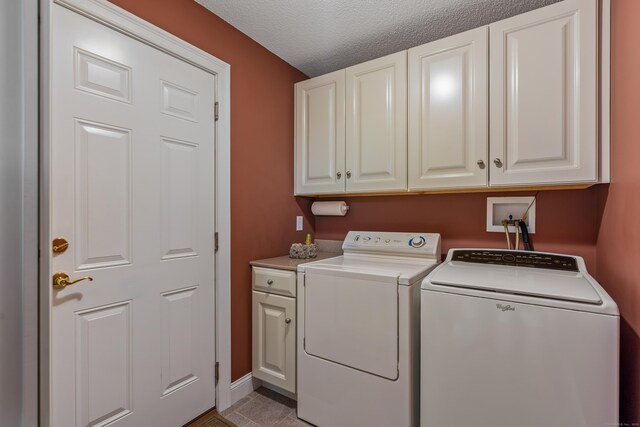 9 Benjamin Ln Unit 9, Tolland, CT 06084 - laundry area with separate washer and dryer, cabinet space, a textured ceiling, and baseboards