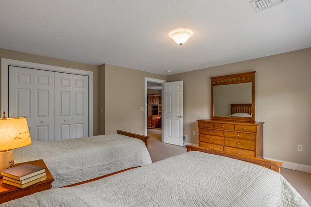 9 Benjamin Ln Unit 9, Tolland, CT 06084 - bedroom featuring a closet, baseboards, and light carpet