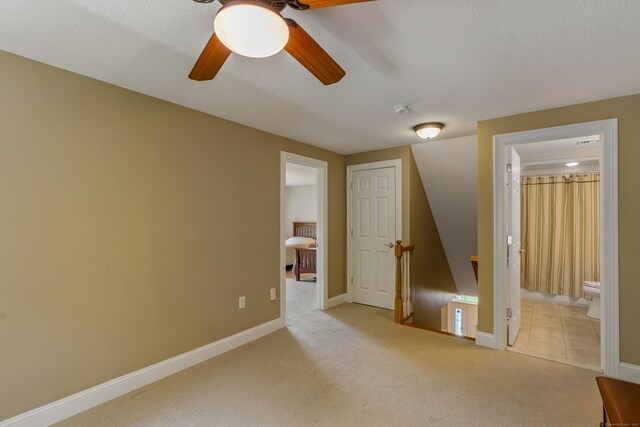 9 Benjamin Ln Unit 9, Tolland, CT 06084 - unfurnished bedroom featuring carpet floors, connected bathroom, ceiling fan, and baseboards