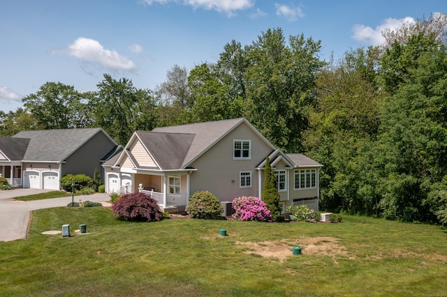 9 Benjamin Ln Unit 9, Tolland, CT 06084 - traditional home featuring driveway, a garage, a front yard, and covered porch