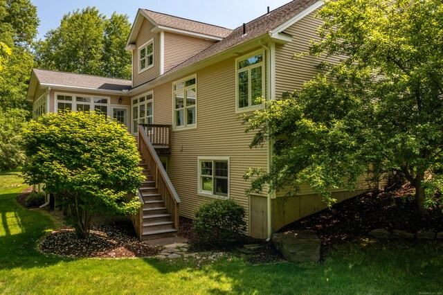9 Benjamin Ln Unit 9, Tolland, CT 06084 - rear view of house featuring stairs, a lawn, a deck, and roof with shingles