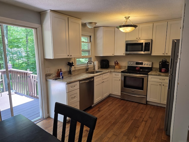 46 Richardson Hill Rd, Griswold, CT 06351 - kitchen featuring stainless steel appliances, plenty of natural light, dark wood-style flooring, and a textured ceiling
