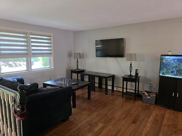46 Richardson Hill Rd, Griswold, CT 06351 - living room featuring wood finished floors, baseboard heating, and a textured ceiling