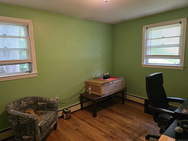46 Richardson Hill Rd, Griswold, CT 06351 - home office with wood-type flooring, plenty of natural light, a baseboard heating unit, and a textured ceiling