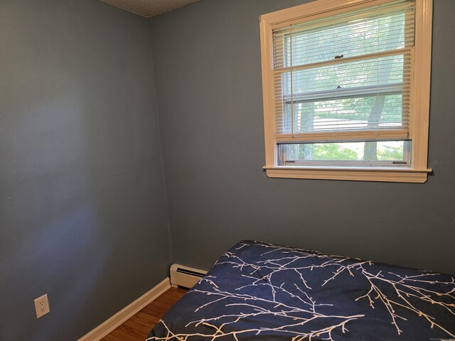 46 Richardson Hill Rd, Griswold, CT 06351 - bedroom featuring baseboard heating and dark wood-type flooring
