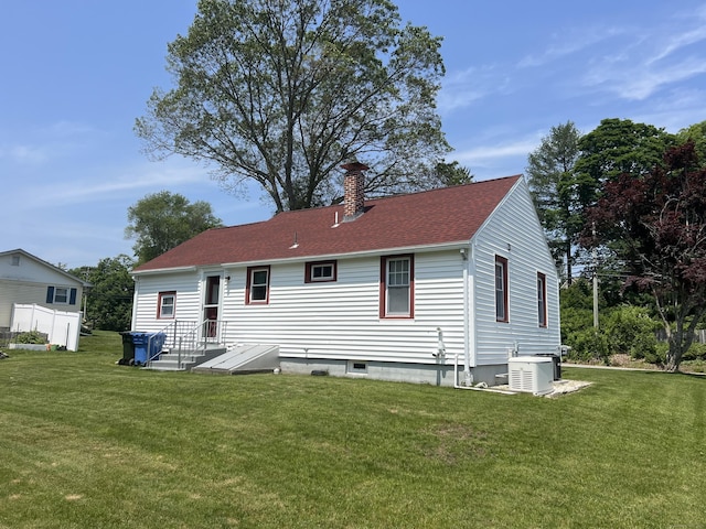 323 Harland Rd, Norwich, CT 06360 - back of house featuring a chimney, a yard, central AC, and a shingled roof